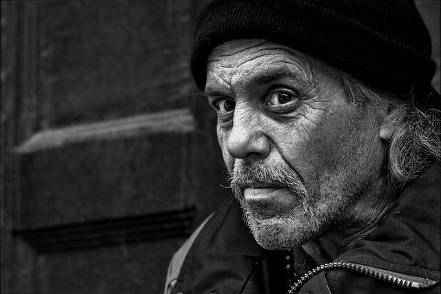 What life can teach us - A black and white of a older man with a winter hate on