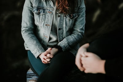 Trauma-informed care - what is it and how can it help?Women in a jean jacket sitting across form a therapist