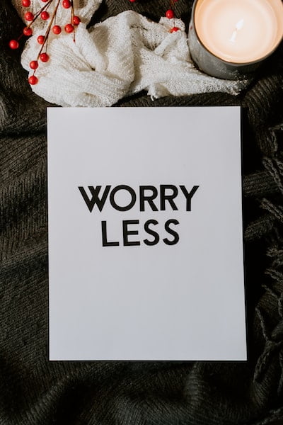 10 of the best ways to reduce stress. A white piece of paper that says, worry less in big bold letters